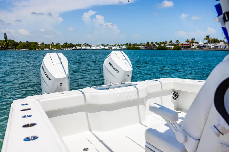 Slide: The Image of 2024 Freeman 34VH boat with dual Mercury engines on a sunny day. - 28