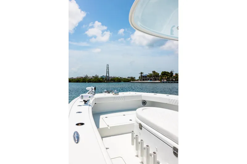 Slide: The Image of 2024 Freeman 34VH boat on calm water, clear sky, and distant shoreline. - 19
