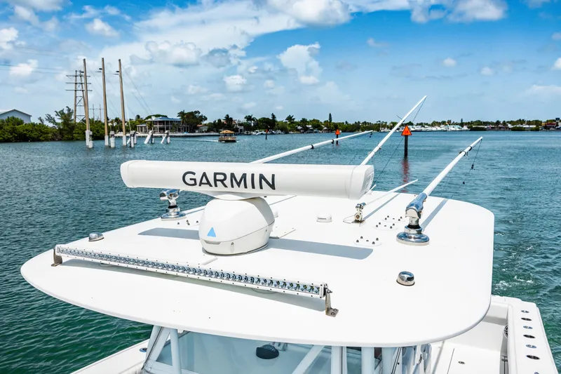 Slide: The Image of 2024 Freeman 34VH boat with Garmin radar on calm waters under blue sky. - 37