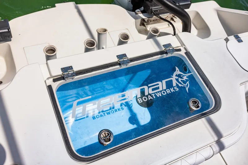Slide: The Image of Freeman 34VH 2024 boat deck with logo and fishing rod holders. - 30