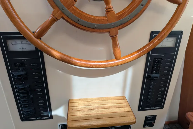 Slide: The Image of Wooden helm and control panels of a 2001 Nordic Tug 32 boat. - 39