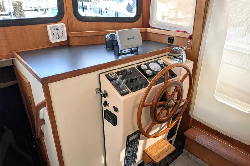 Slide: The Image of Helm of 2001 Nordic Tug 32 with wooden wheel and Garmin navigation system. - 33