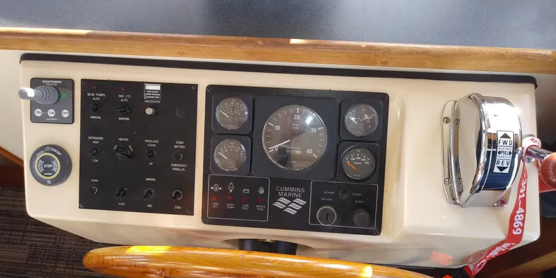 Slide: The Image of The image shows the dashboard of a 2001 Nordic Tug 32 with various instruments and controls. - 27
