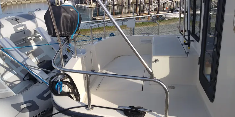 Slide: The Image of The image shows the deck of a 2001 Nordic Tug 32 in a harbor. - 5