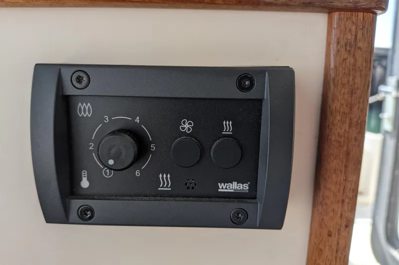 Slide: The Image of Control panel of a 2001 Nordic Tug 32 boat with Wallas heater settings. - 43