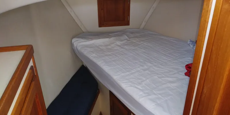 Slide: The Image of Cabin with a double bed and wooden furnishings in a Nordic Tug 32 boat. - 40