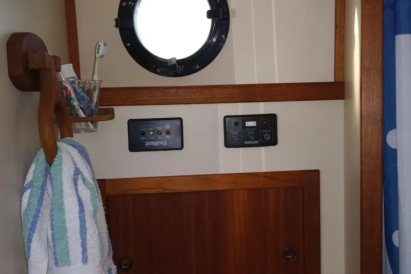 Slide: The Image of Interior of a 2001 Nordic Tug 32 with porthole, towel rack, and control panel. - 42