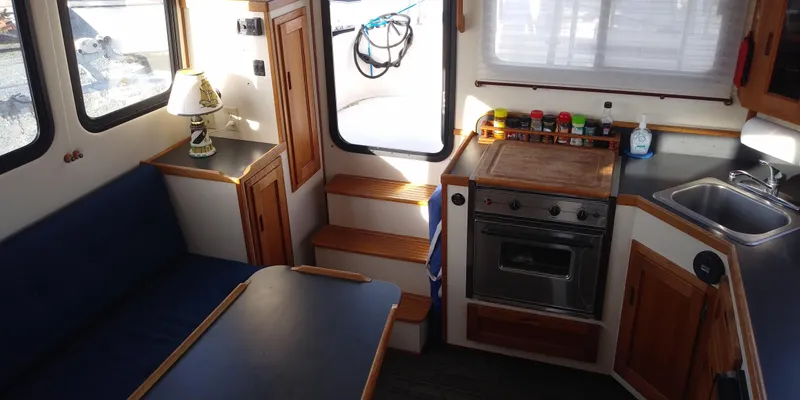 Slide: The Image of Interior of a 2001 Nordic Tug 32 with kitchen and seating area. - 21