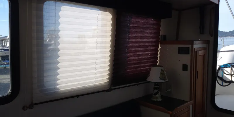 Slide: The Image of Interior of a 2001 Nordic Tug 32 with windows and blinds. - 23