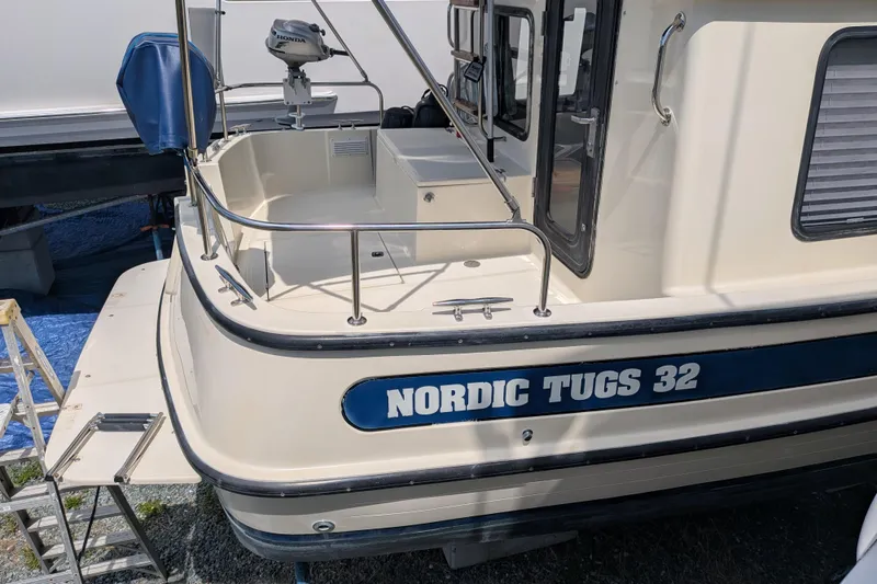 Slide: The Image of 2001 Nordic Tug 32 boat with spacious deck and railing, docked outdoors. - 7