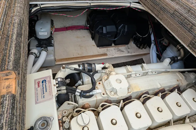 Slide: The Image of Engine compartment of a 2001 Nordic Tug 32, showcasing mechanical components and wiring. - 61