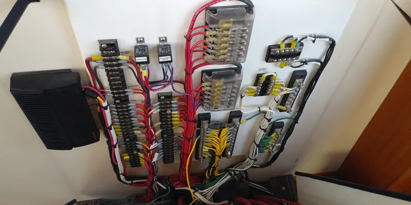 Slide: The Image of Electrical panel with colored wires and fuses inside a boat. - 38