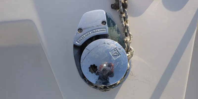 Slide: The Image of Close-up of an anchor system on a boat, featuring a chain and metal cover. - 15