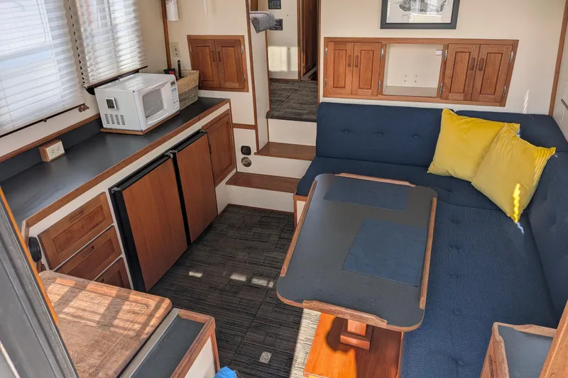 Slide: The Image of Interior of a 2001 Nordic Tug 32 with kitchenette and cozy seating area. - 20