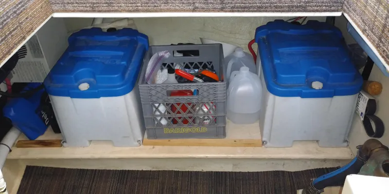 Slide: The Image of Storage area with two blue containers and a crate holding tools and accessories. - 46
