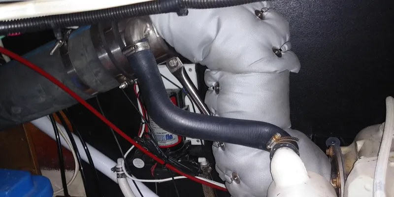 Slide: The Image of Insulated pipes and hoses in a boat's engine compartment. - 48