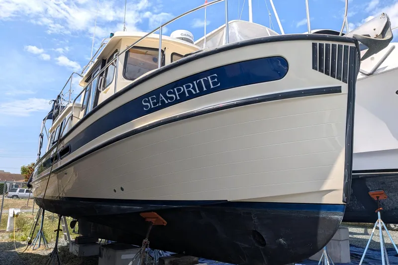 Slide: The Image of 2001 Nordic Tug 32 "Seasprite" boat on dry dock under a clear blue sky. - 3