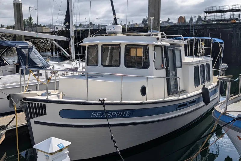 The Image of 2001 Nordic Tug 32 "Seasprite" docked at marina, showcasing classic design and sturdy build. - 1