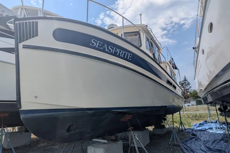 Slide: The Image of 2001 Nordic Tug 32 "Seasprite" on dry dock, showcasing its classic design and sturdy build. - 4