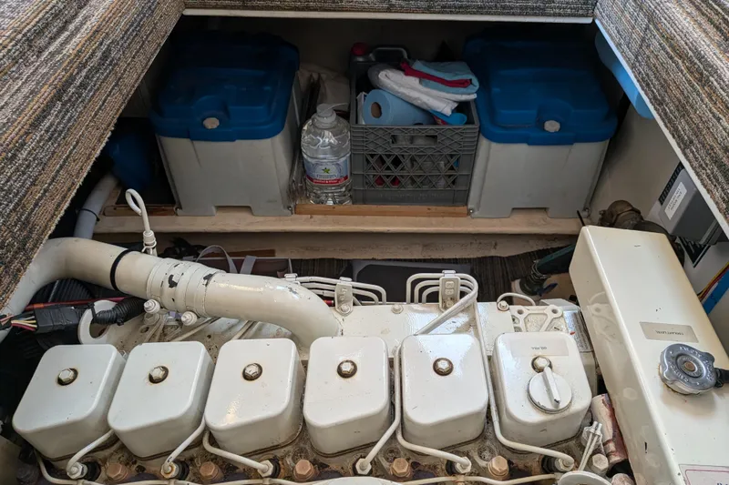 Slide: The Image of Engine compartment of a 2001 Nordic Tug 32, featuring storage and maintenance items. - 62