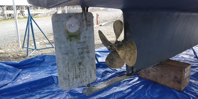 Slide: The Image of Close-up of the propeller and hull of a 2001 Nordic Tug 32 on a blue tarp. - 54