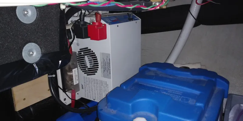 Slide: The Image of Electrical components in a boat engine room, including a battery and wiring. - 47