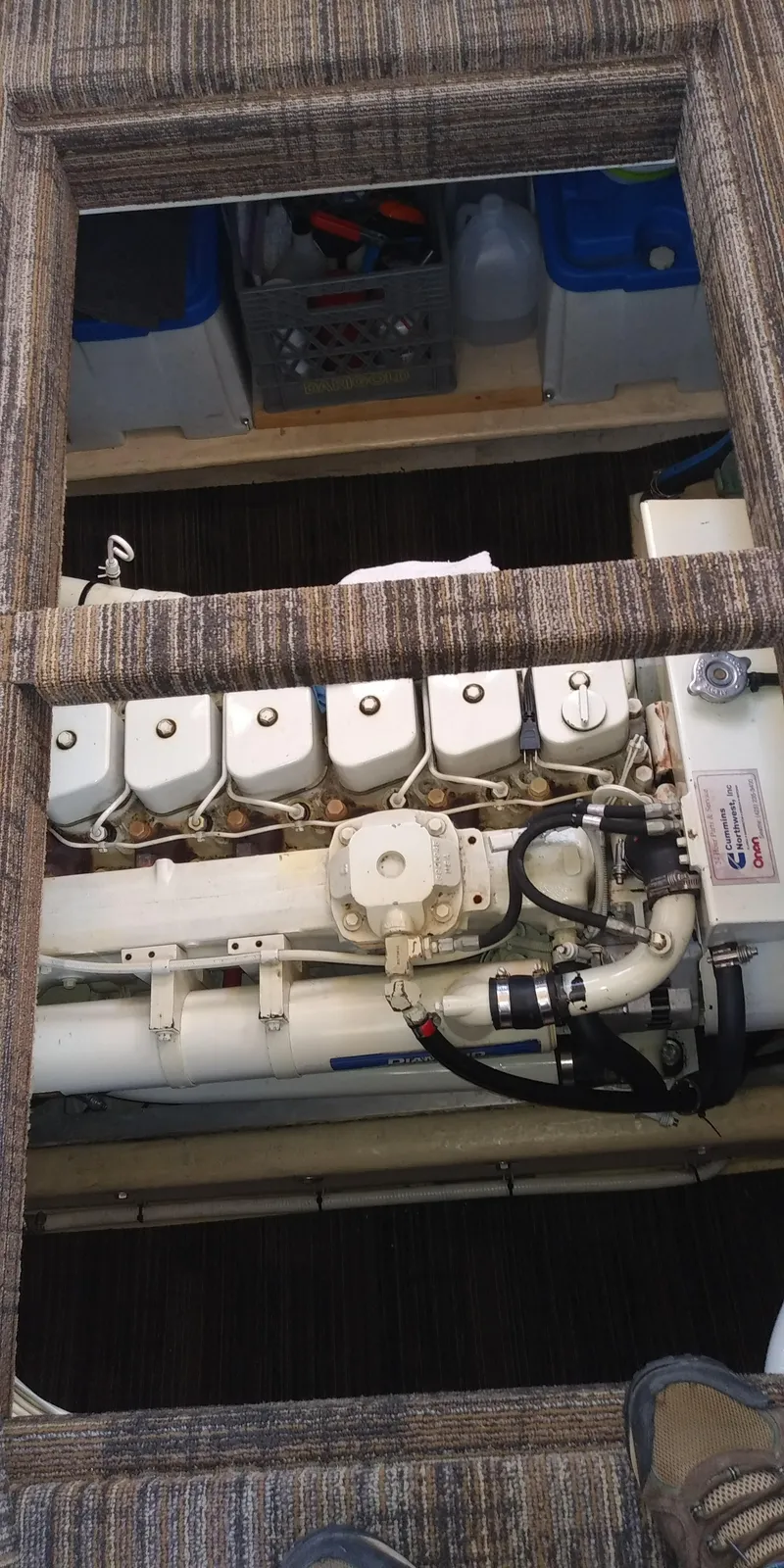 Slide: The Image of An engine compartment with an exposed engine beneath a carpeted floor. - 51