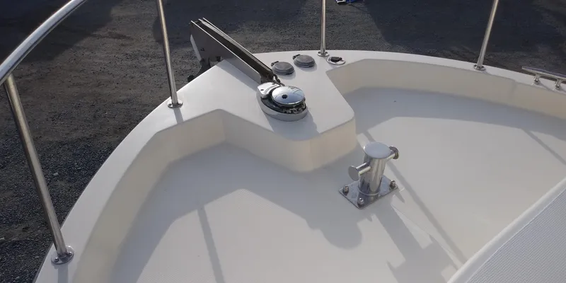 Slide: The Image of Bow of a 2001 Nordic Tug 32 with windlass and cleat. - 13