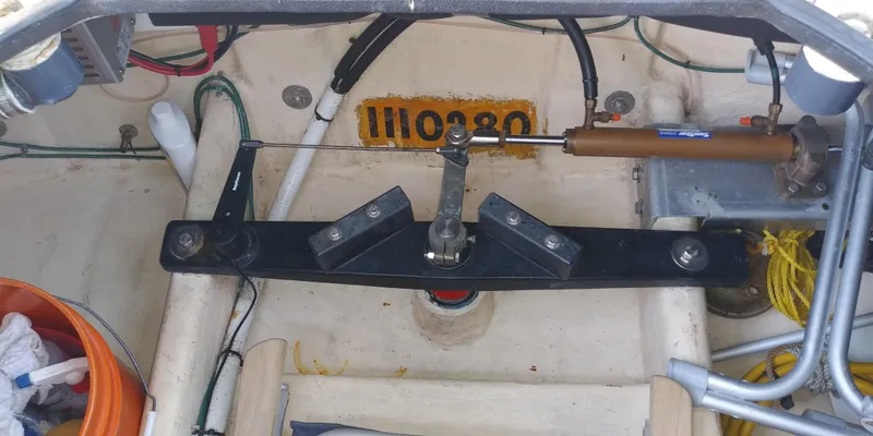 Slide: The Image of The image shows a boat's steering mechanism with hydraulic cylinder and various cables. - 52