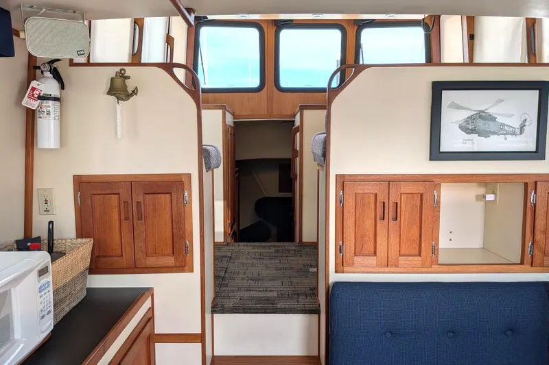 Slide: The Image of Interior of a 2001 Nordic Tug 32 boat with wooden cabinets and nautical decor. - 30