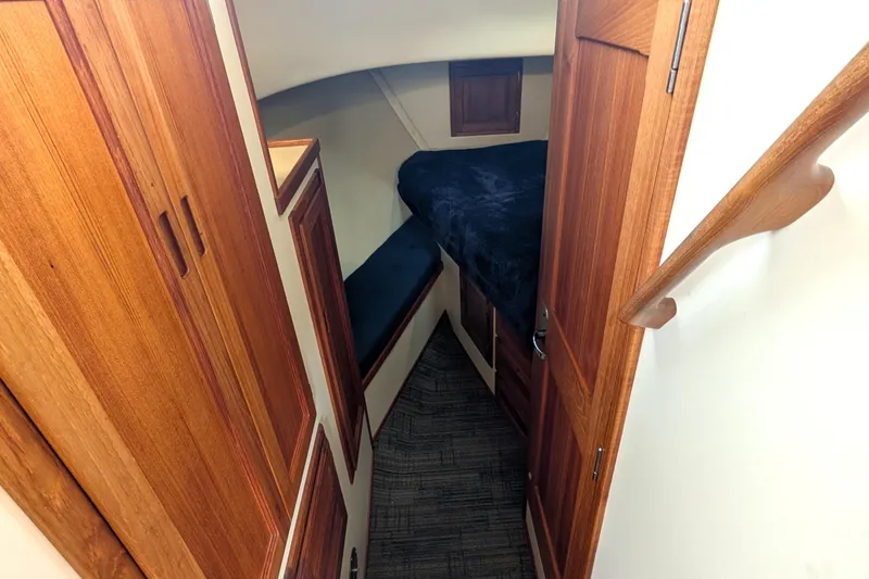 Slide: The Image of Cozy cabin interior of 2001 Nordic Tug 32 with wooden finishes and compact sleeping area. - 50