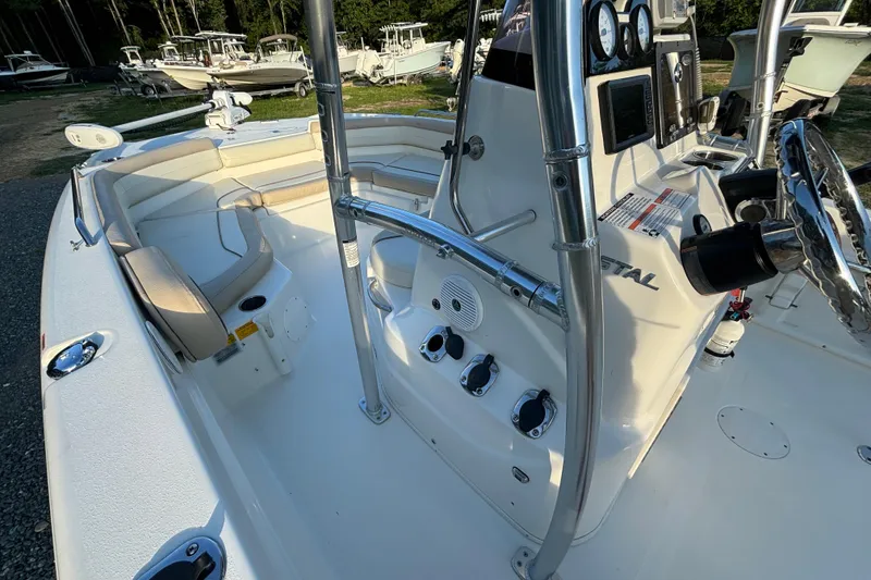 Slide: The Image of 2018 NauticStar 211 Coastal boat interior with steering console and seating area. - 5