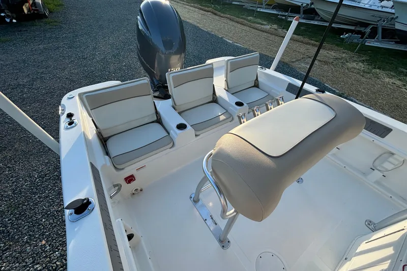 Slide: The Image of 2018 NauticStar 211 Coastal boat interior with seating and motor, viewed from above. - 13