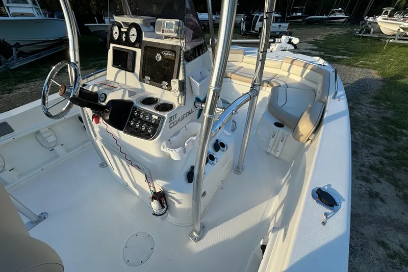 Slide: The Image of 2018 NauticStar 211 Coastal boat interior with steering console and seating area. - 11