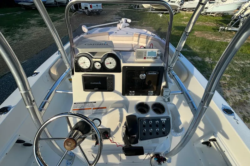 Slide: The Image of 2018 NauticStar 211 Coastal boat dashboard with Garmin navigation and control panel. - 7