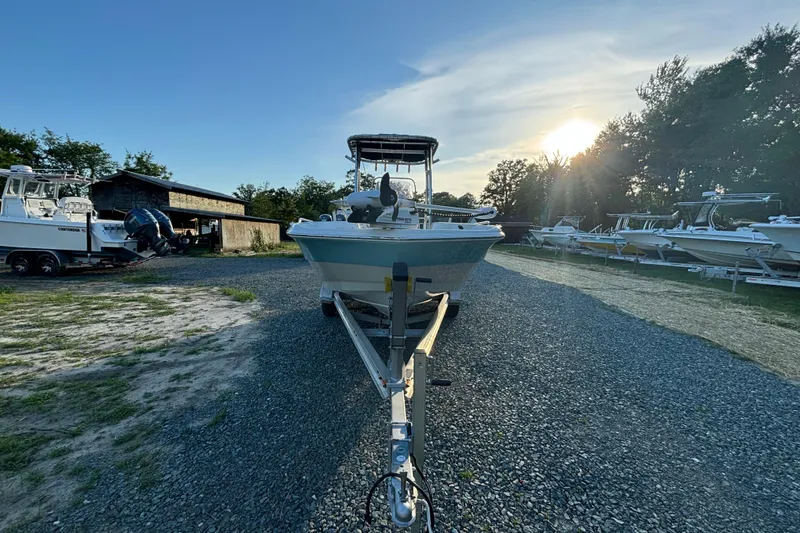 Slide: The Image of 2018 NauticStar 211 Coastal boat on trailer, parked outdoors at sunset. - 6