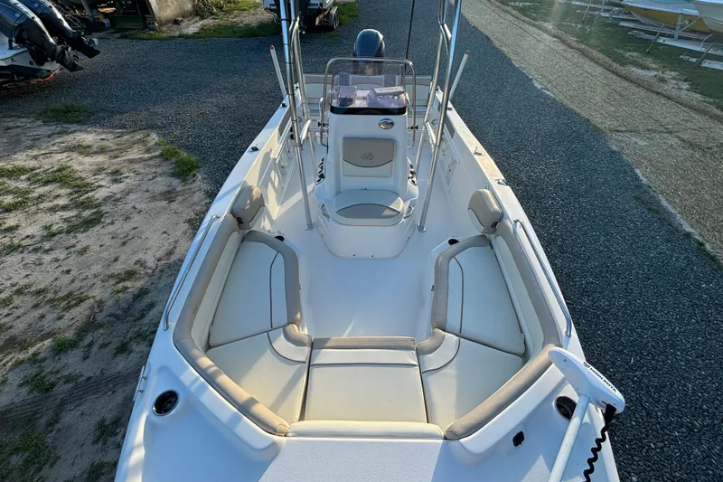 Slide: The Image of 2018 NauticStar 211 Coastal boat interior with seating and steering console. - 14