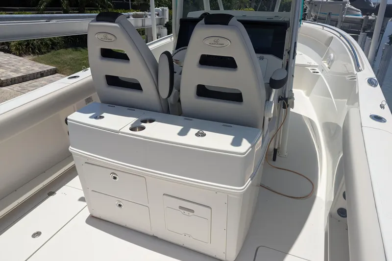 Slide: The Image of 2023 Sailfish 290 CC boat interior with dual seats and storage compartments. - 10