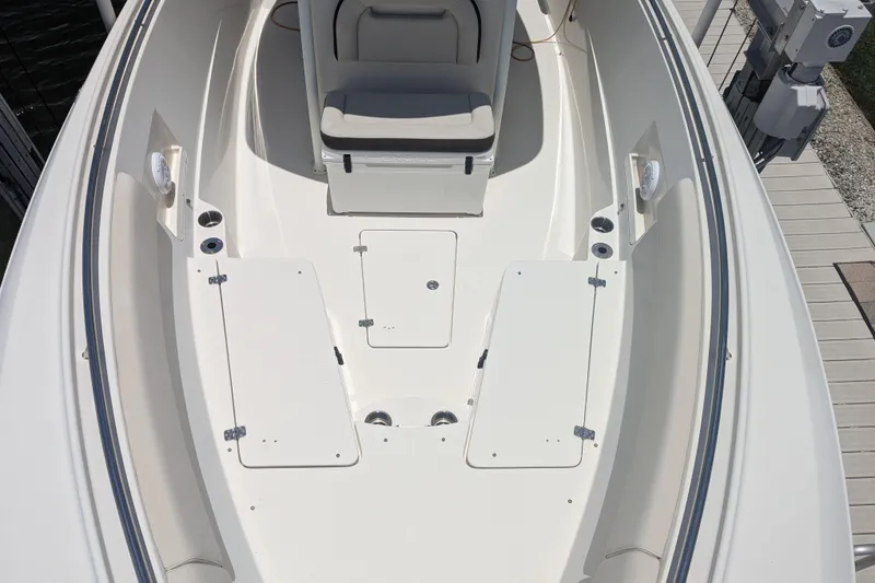 Slide: The Image of 2023 Sailfish 290 CC boat deck with seating and storage compartments. - 7