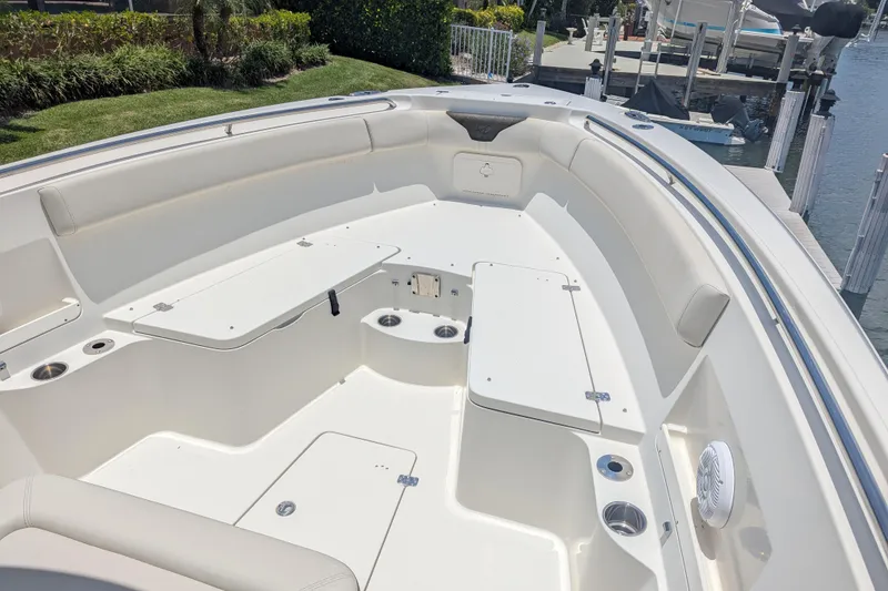 Slide: The Image of 2023 Sailfish 290 CC boat interior with spacious seating and storage compartments. - 6
