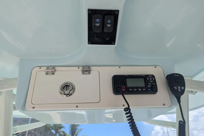 Slide: The Image of Control panel of 2023 Sailfish 290 CC boat with radio and storage compartment. - 9