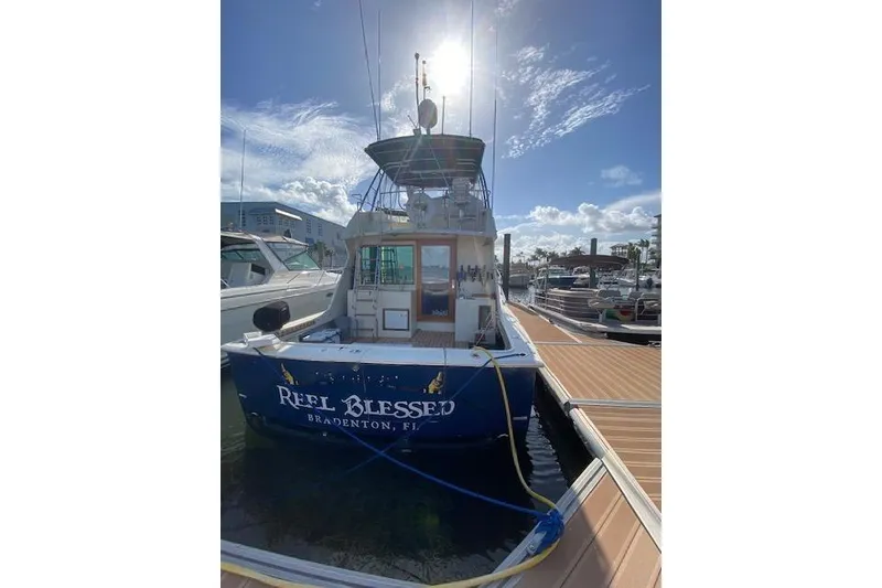 Slide: The Image of 1984 Hatteras 46 Convertible yacht docked, named "Reel Blessed," in Bradenton, Florida. - 1