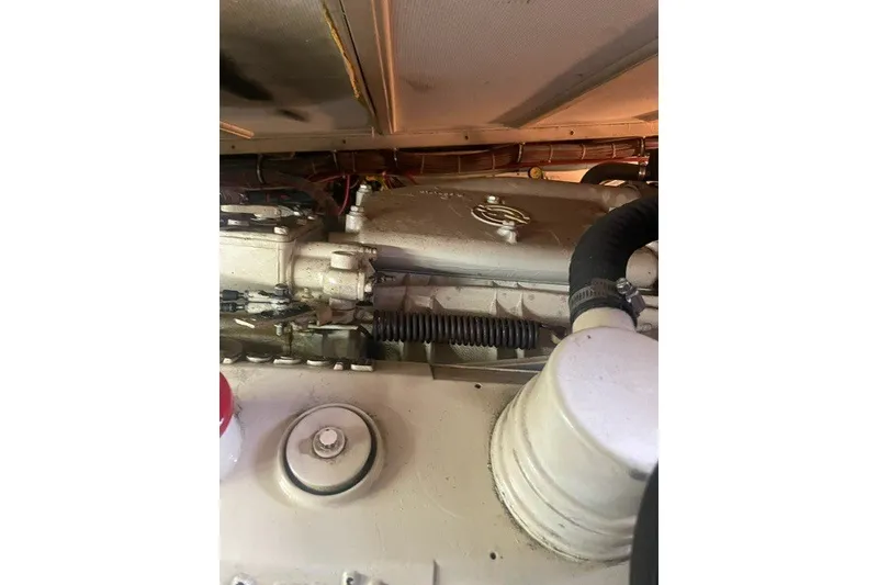 Slide: The Image of Engine compartment of a 1984 Hatteras 46 Convertible boat, showcasing mechanical components. - 51