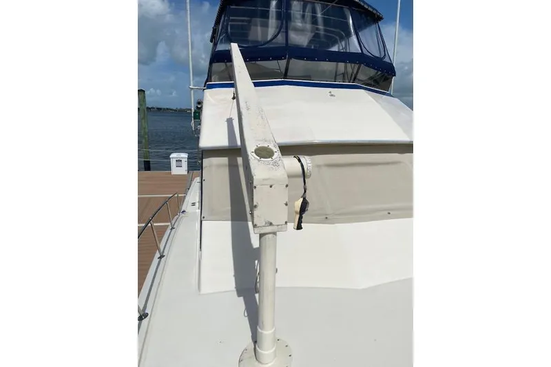 Slide: The Image of 1984 Hatteras 46 Convertible yacht deck with blue canopy and dock view. - 14