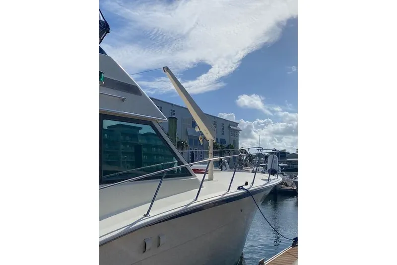 Slide: The Image of 1984 Hatteras 46 Convertible yacht docked under a clear blue sky. - 2