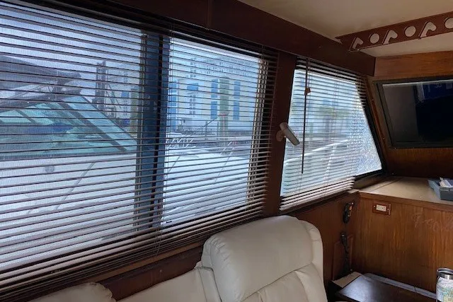 Slide: The Image of Interior view of 1984 Hatteras 46 Convertible yacht with blinds and leather seating. - 43