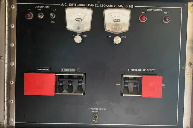 Slide: The Image of A.C. switching panel on 1984 Hatteras 46 Convertible boat, featuring generator and shoreline selectors. - 18