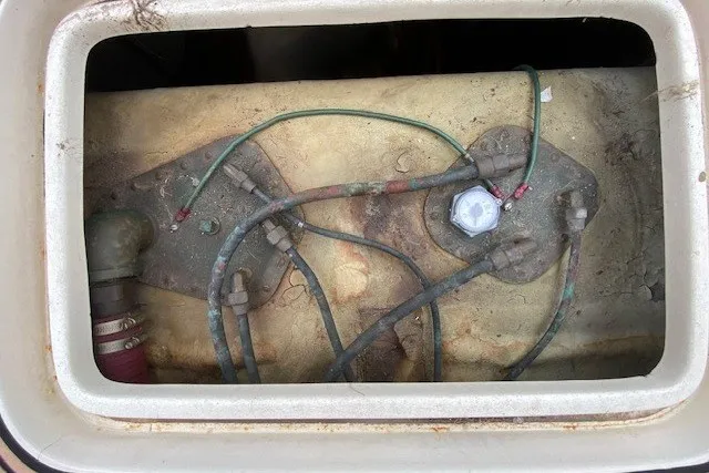 Slide: The Image of 1984 Hatteras 46 Convertible boat wiring and plumbing components in a compartment. - 20