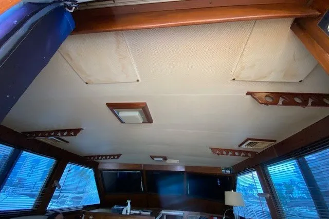 Slide: The Image of Interior view of 1984 Hatteras 46 Convertible yacht with wooden accents and large windows. - 45