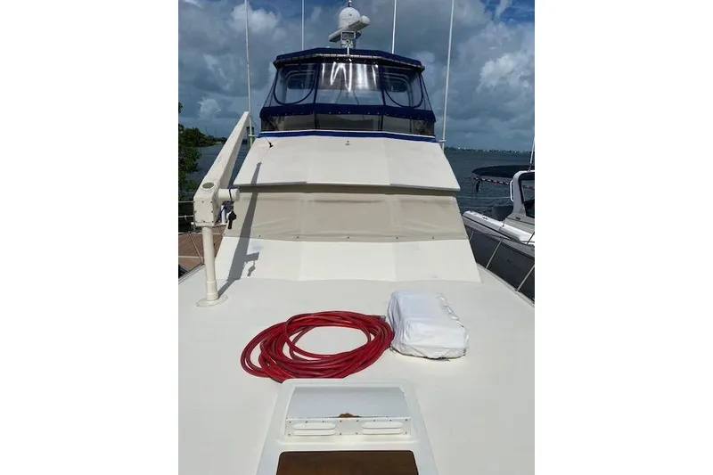 Slide: The Image of 1984 Hatteras 46 Convertible yacht deck with red rope and white cover. - 13